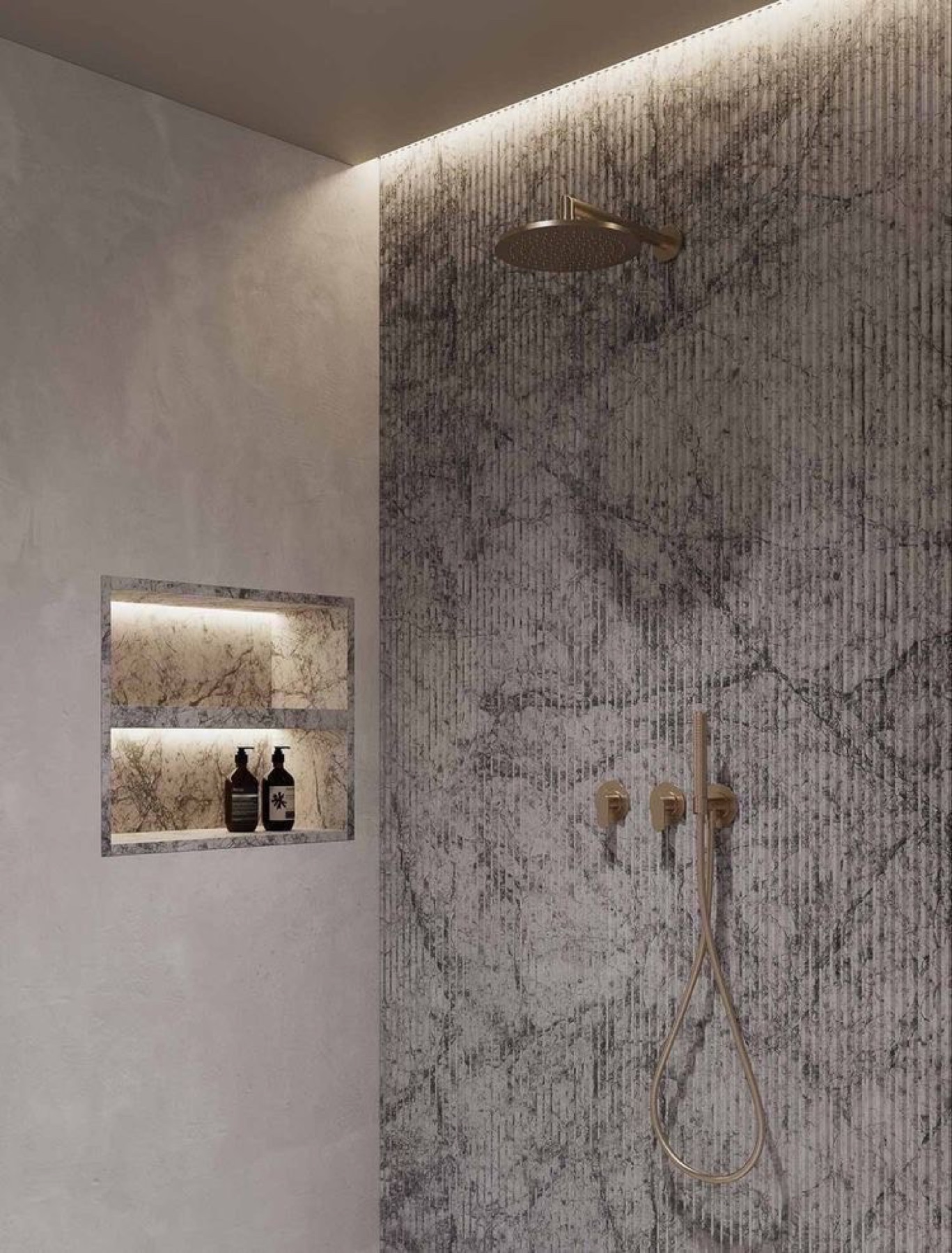 Spa-style shower with veined marble wall and brass fixtures