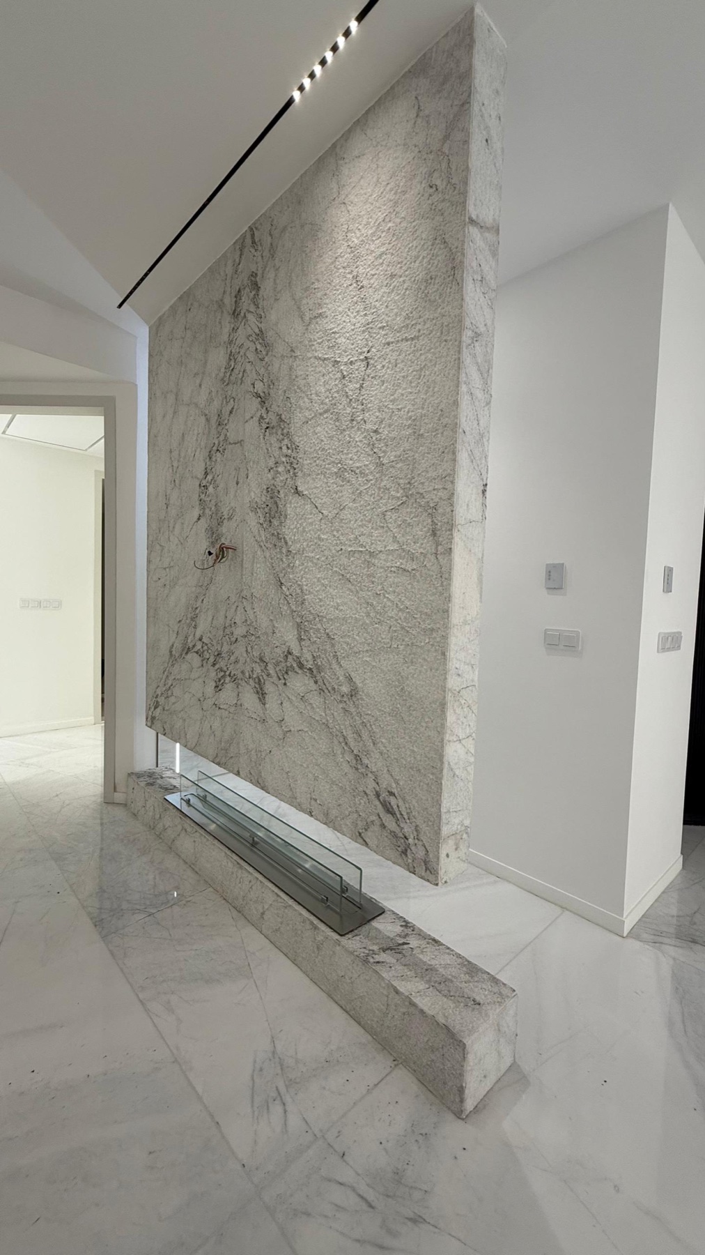 Full marble slab fireplace feature wall